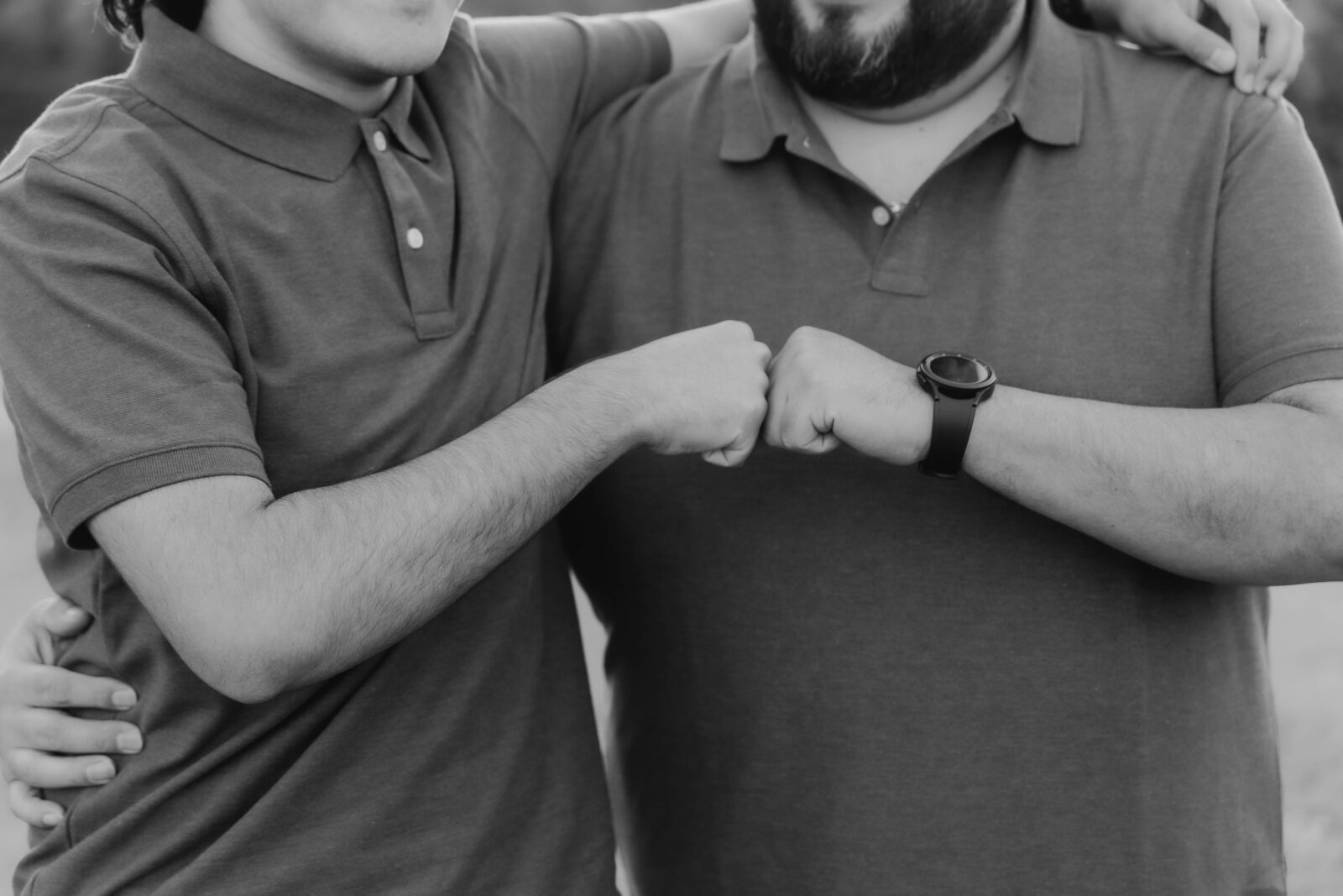 Fist bump photo in black and white during a family photo session.