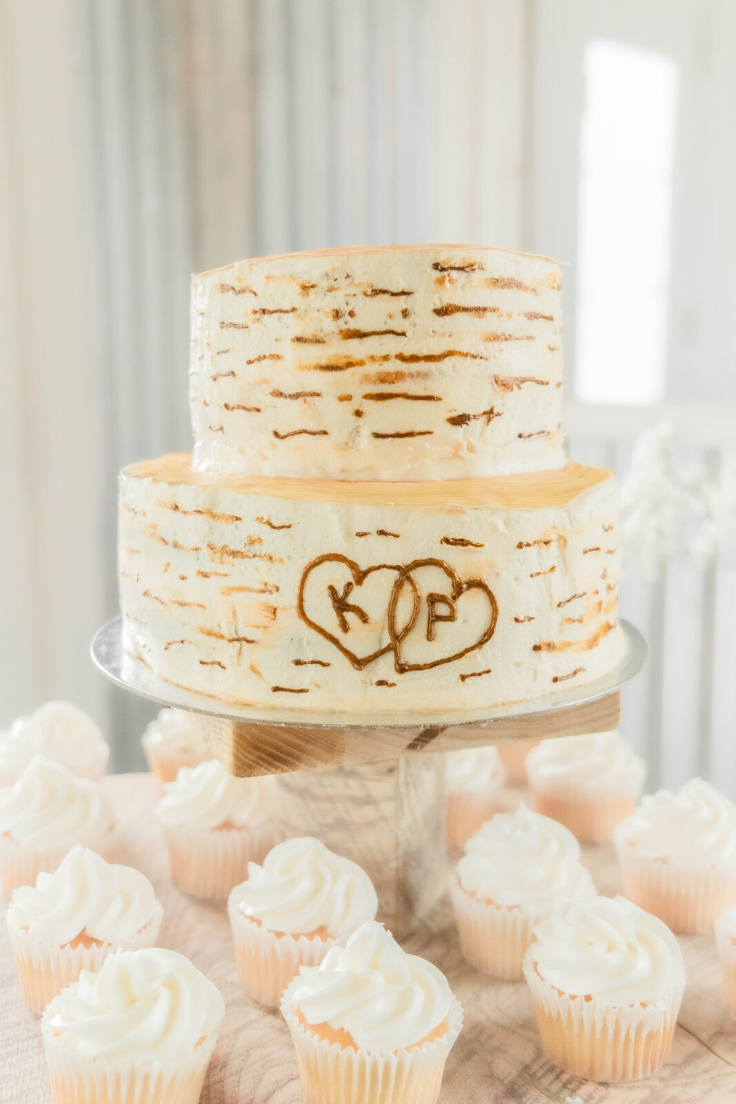 An elegant wedding cake with white cupcakes